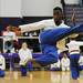 Chris Thompson of Keith Hafner's Karate soars through the air while demonstrating a kick as part of a half time performance at Pioneer High School on Tuesday, Feb. 19, 2013. Melanie Maxwell I AnnArbor.com